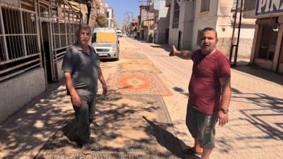 Adana'da tozlu yollara sıra dışı çözüm: Mahalleli sokağa halı serdi